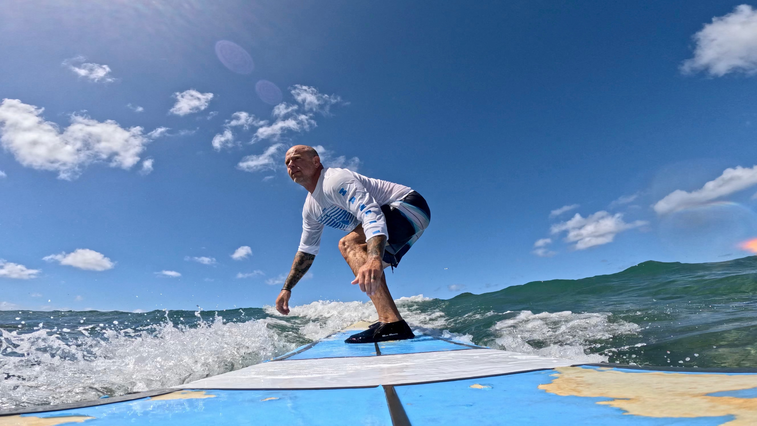 Chris surfing on a wave